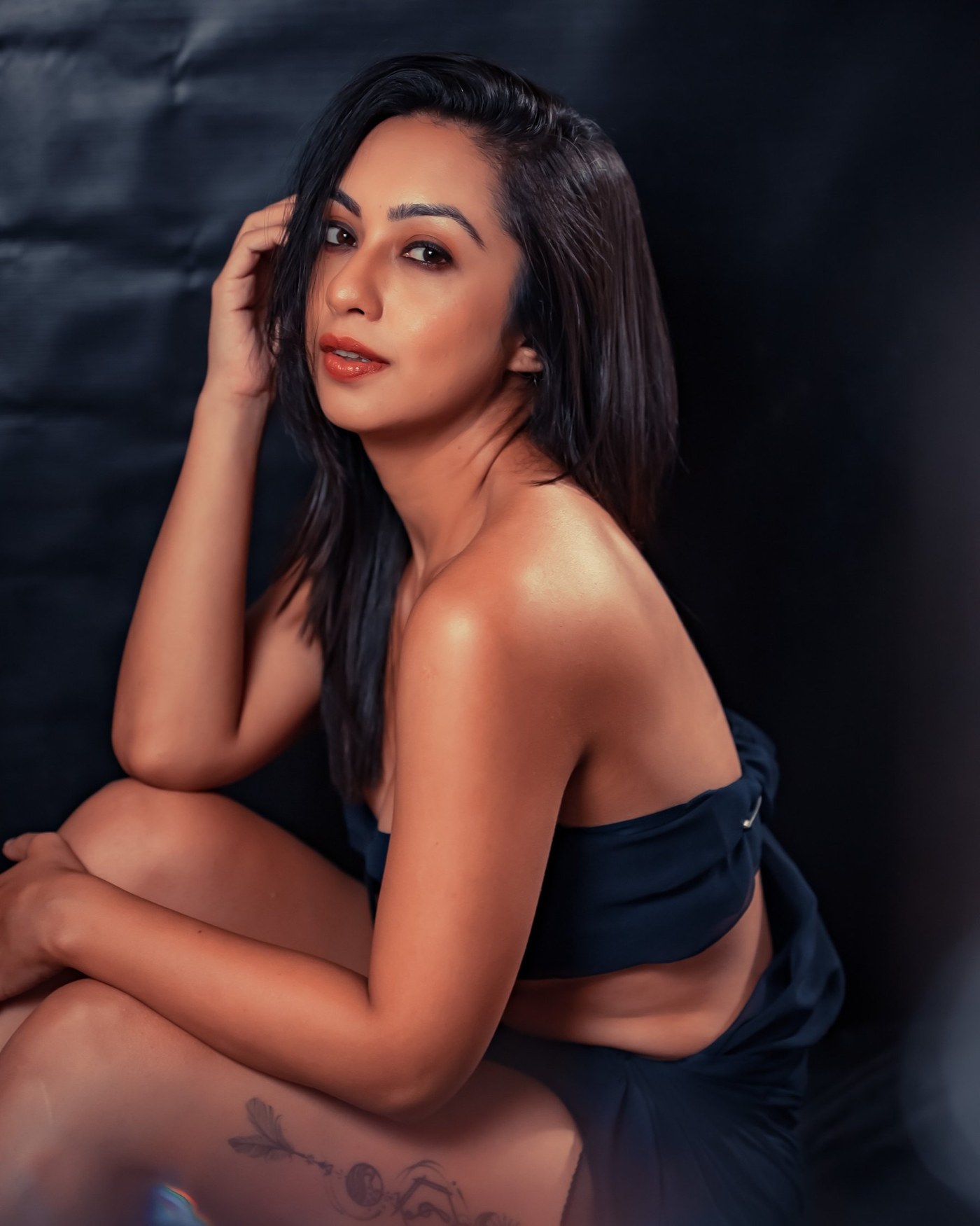 Abigail Pande models a navy two-piece ensemble, showcasing minimalist evening portraiture. - Photos & Updates