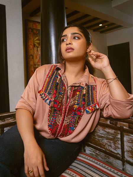 Gouri G Kishan is seen posing in a glamorous emerald green outfit at an event.