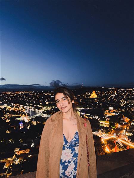 Priya Varrier poses in a striking outfit, capturing the essence of both day and night.