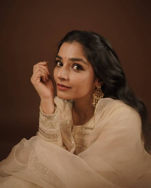 Rajisha Vijayan posing at an event, radiating elegance in a stylish outfit.