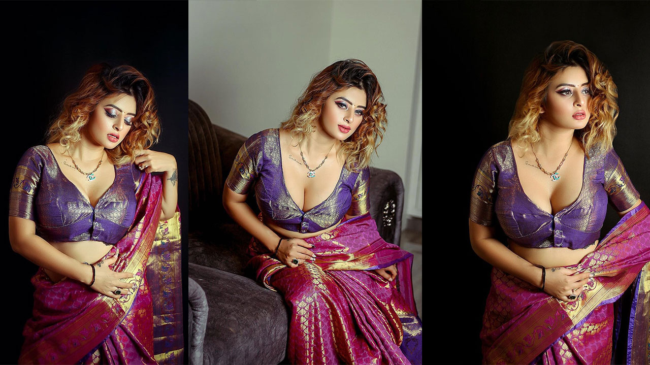 Ankita Dave wearing a deep purple and magenta saree with intricate gold embellishments and flowing hair.