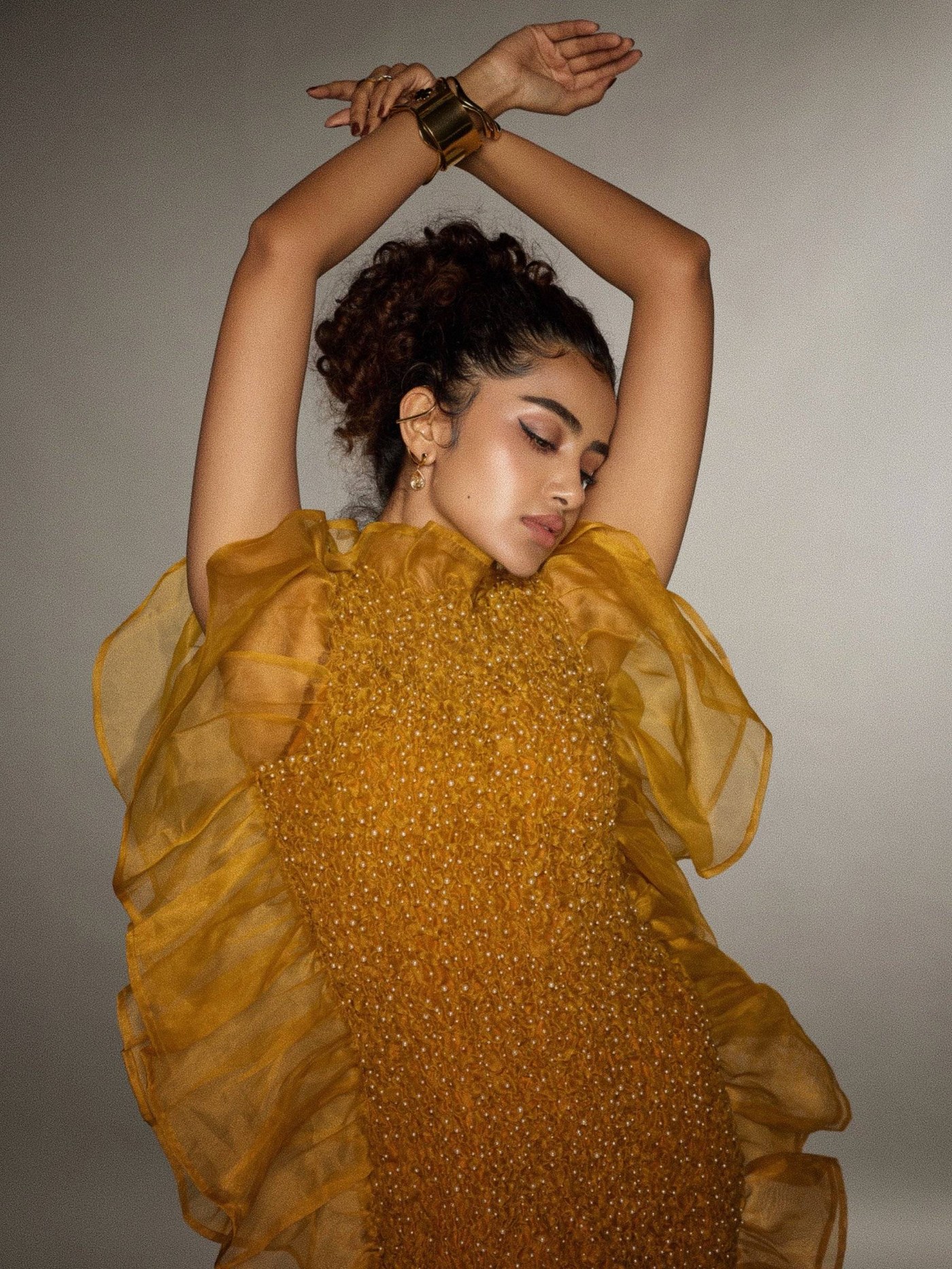 Mustard Gold Gown: Anupama Parameswaran's Dramatic Silhouette