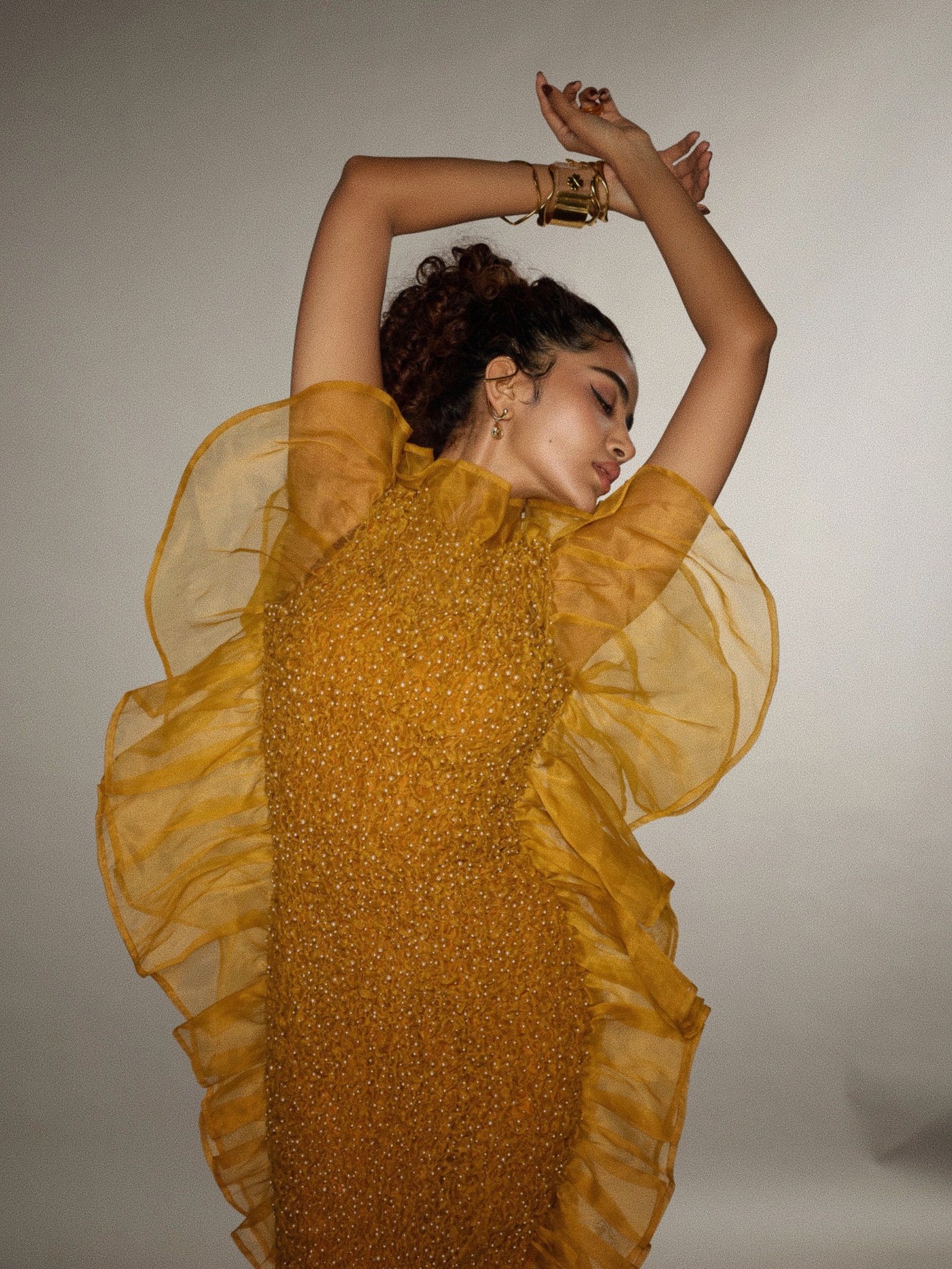 Mustard Gold Gown: Anupama Parameswaran's Dramatic Silhouette