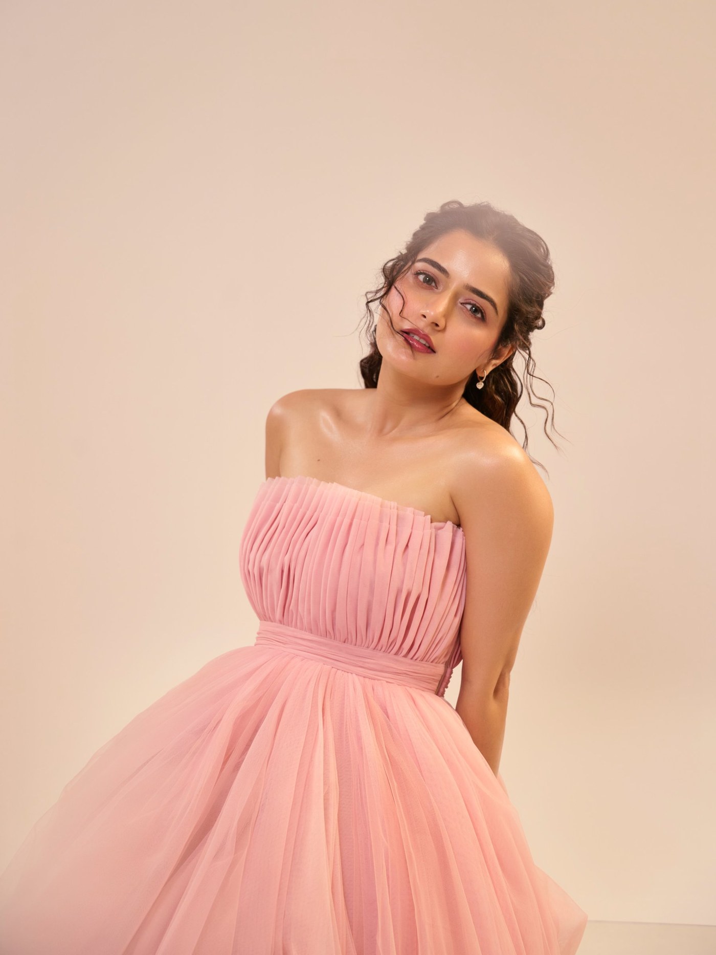 Ashika Ranganath is captured in a light, flowing pastel gown, showcasing contemporary feminine silhouettes.