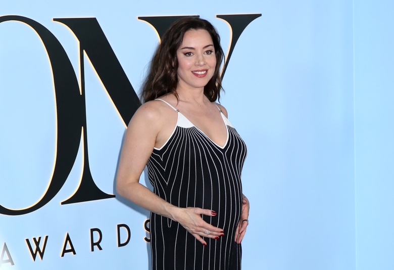 Aubrey Plaza posing confidently in a striking outfit at an event.