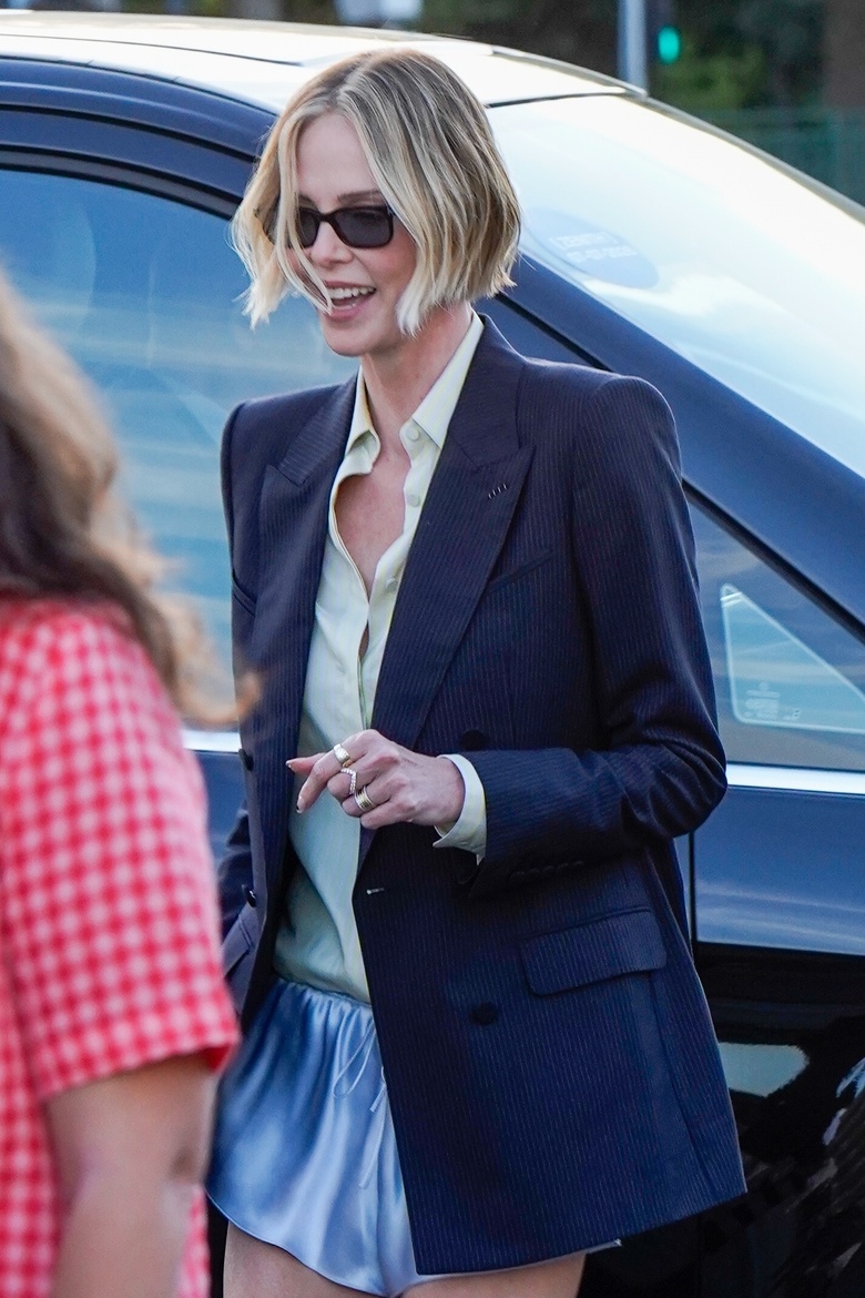 Charlize Theron poses elegantly at The Odyssey Special Event, radiating timeless Hollywood glamour in Paris.