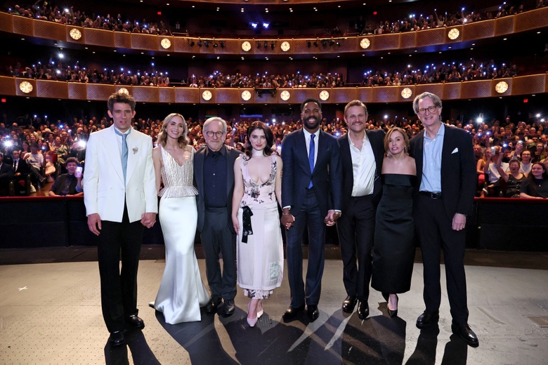 Emily Blunt posing elegantly at a formal event, showcasing sophisticated attire.