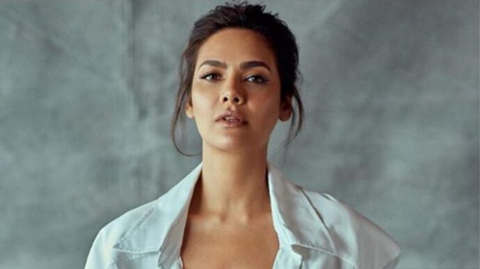 Esha Gupta poses elegantly in a light pink embroidered ensemble with statement jewelry.