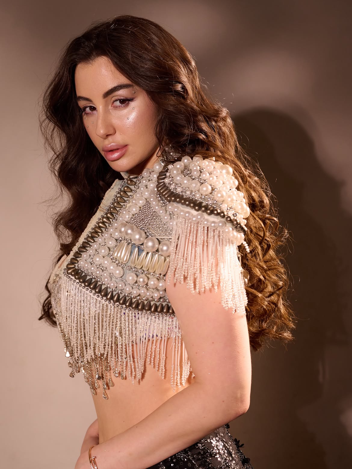 Giorgia Andriani shines in a metallic-inspired ensemble featuring intricate beadwork and shimmering textures.