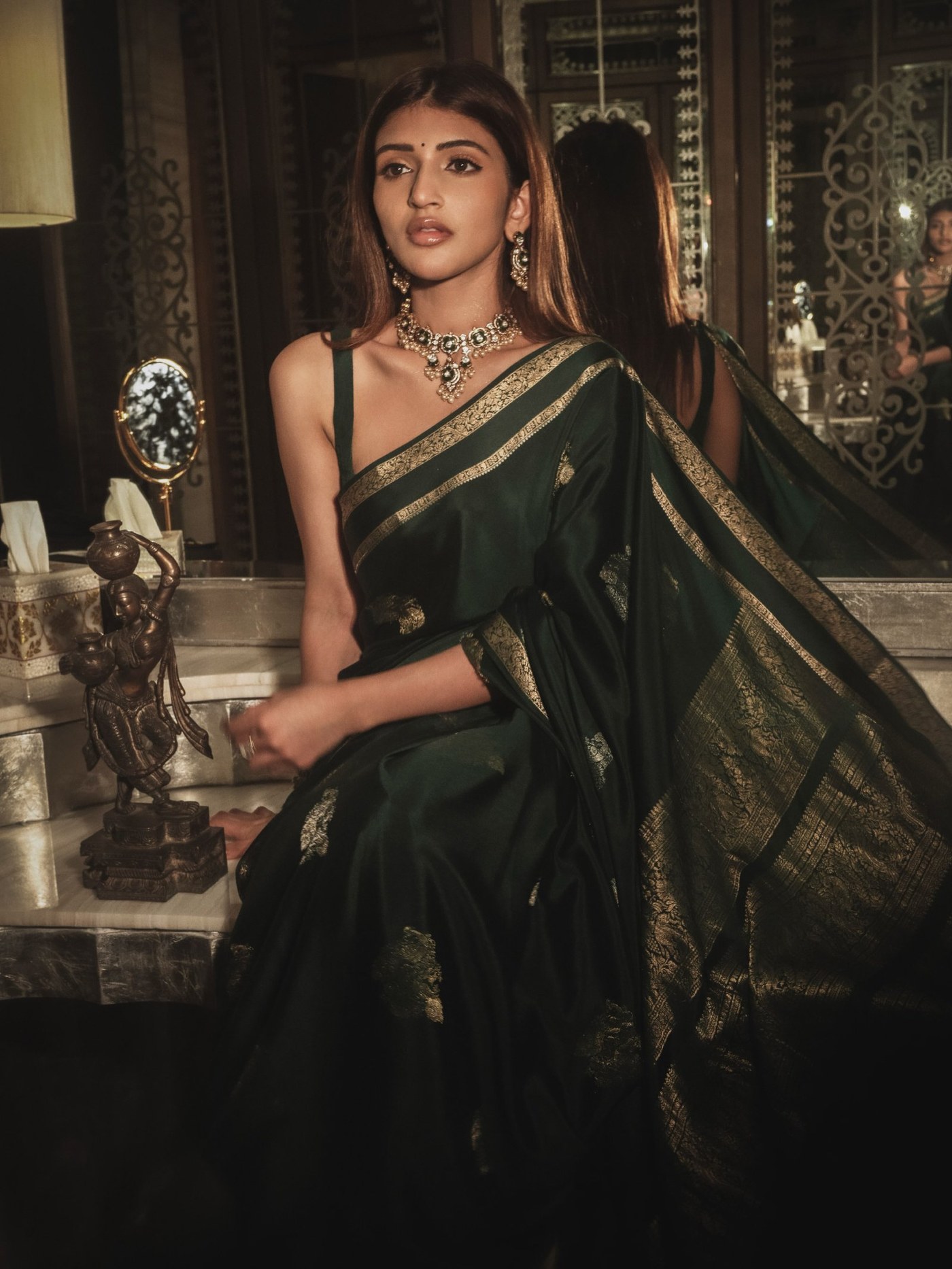 Sreeleela showcases timeless grace in a richly woven, jewel-toned green saree at a festive event.