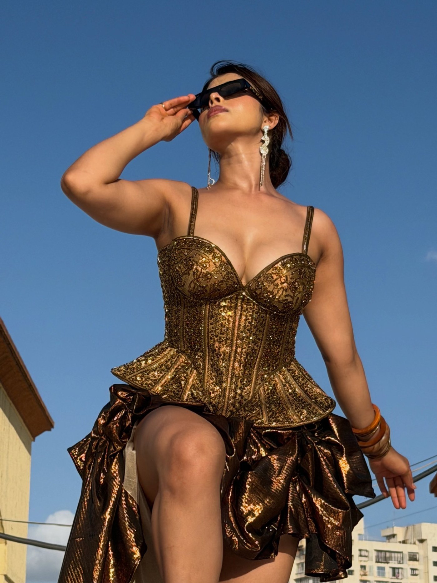 Mahima Gupta radiates confidence in a bold, glamorous ensemble featuring rich textures and contemporary metallic accents.