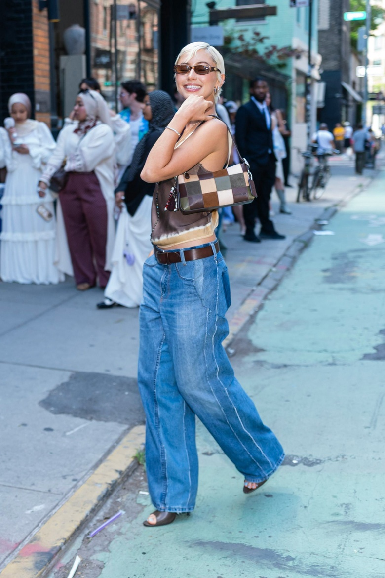 Iris Law is photographed exploring the vibrant streets of New York City, radiating effortless style.