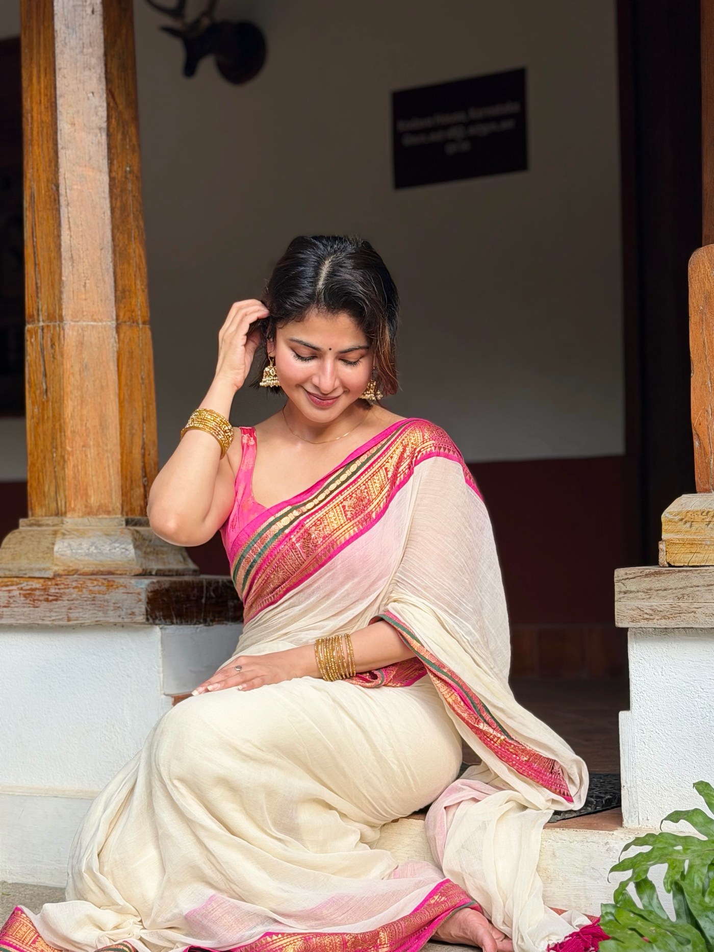 Iswarya Menon showcases a beautiful off-white saree with vibrant pink and gold detailing for the festive season. - Photos & Updates