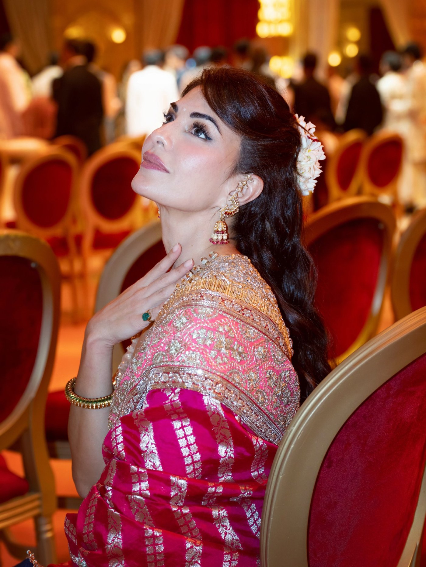 Jacqueline Fernandez showcases a vibrant fuchsia sari in an ornate setting. - Photos & Updates