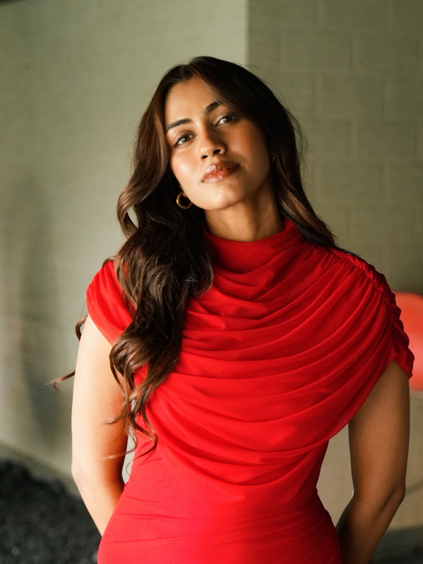 Apeksha Porwal in a bright red sleeveless top indoors. - Photos & Updates