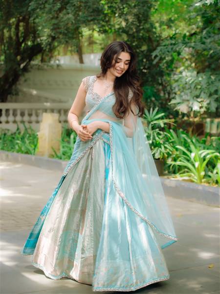 Krithi Shetty radiates elegance in a vibrant blue, intricately designed traditional lehenga ensemble.