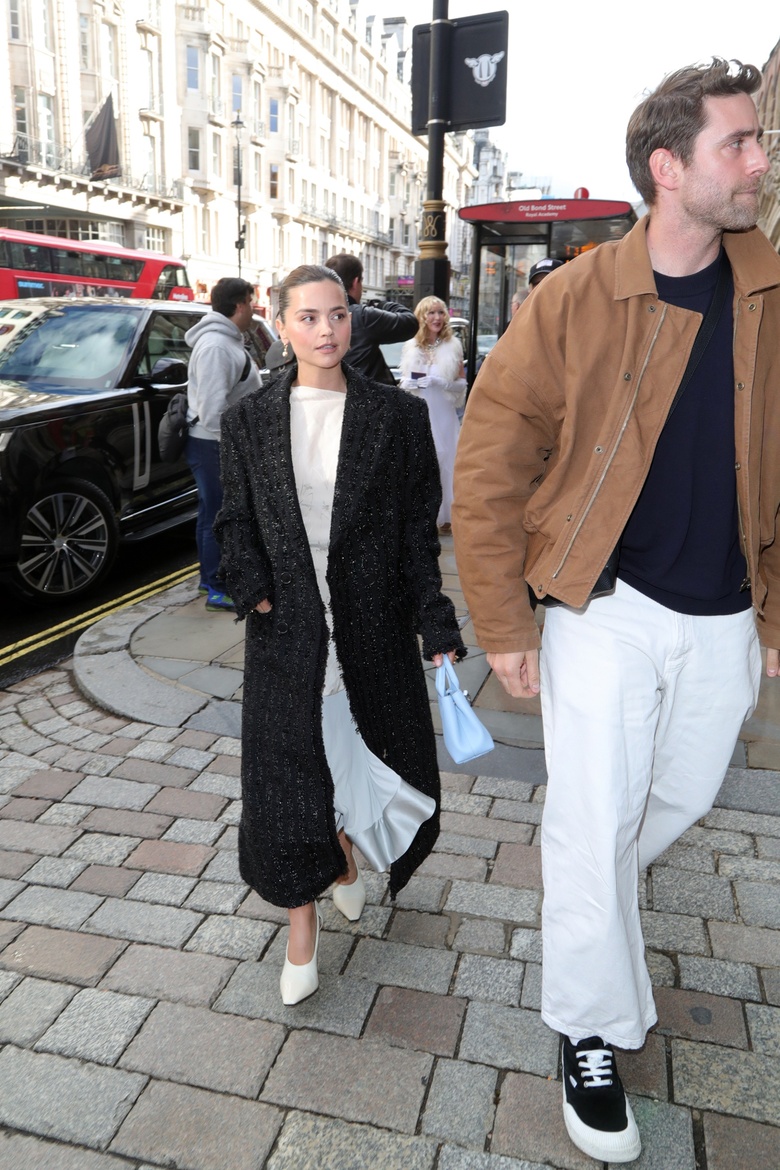 Jenna Coleman posing elegantly at an event, showcasing a vibrant and stylish ensemble.