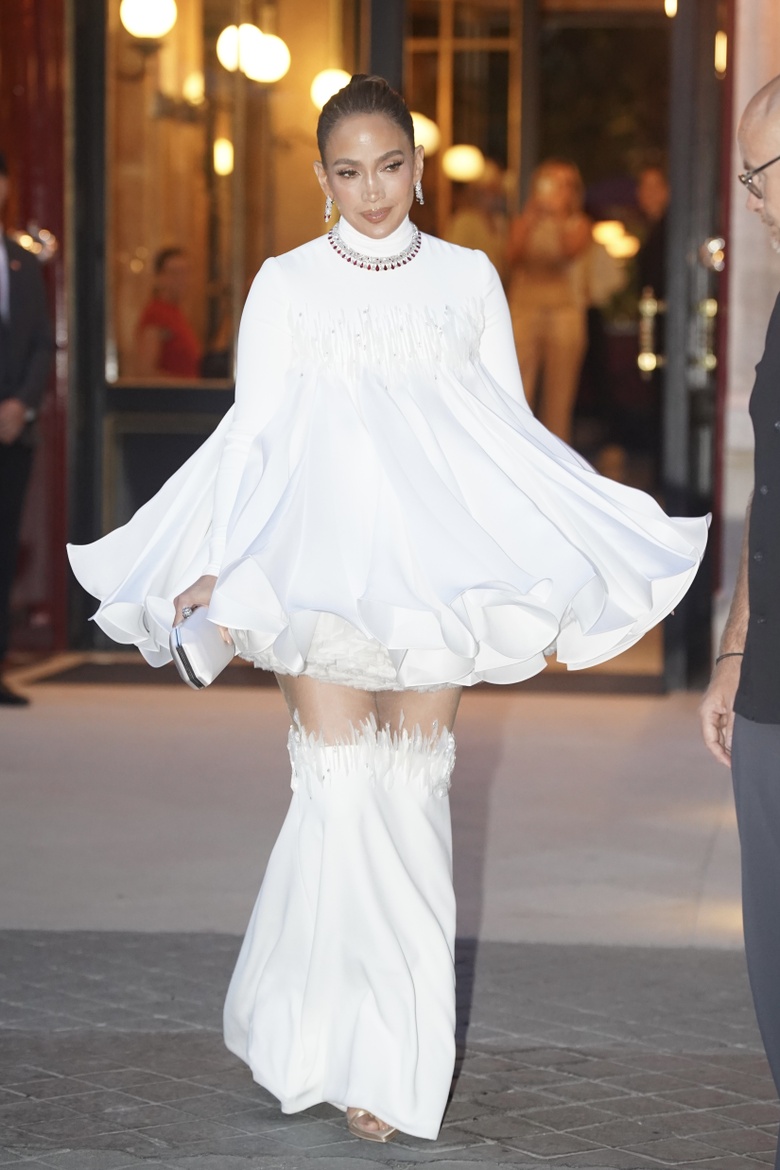 Jennifer Lopez is spotted in a magnificent white gown at an upscale architectural entrance.