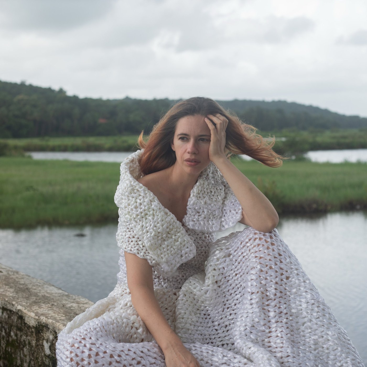 Kalki Koechlin poses in an experimental white dress crafted from recycled plastic bags, embodying artistic grace. - Photos & Updates