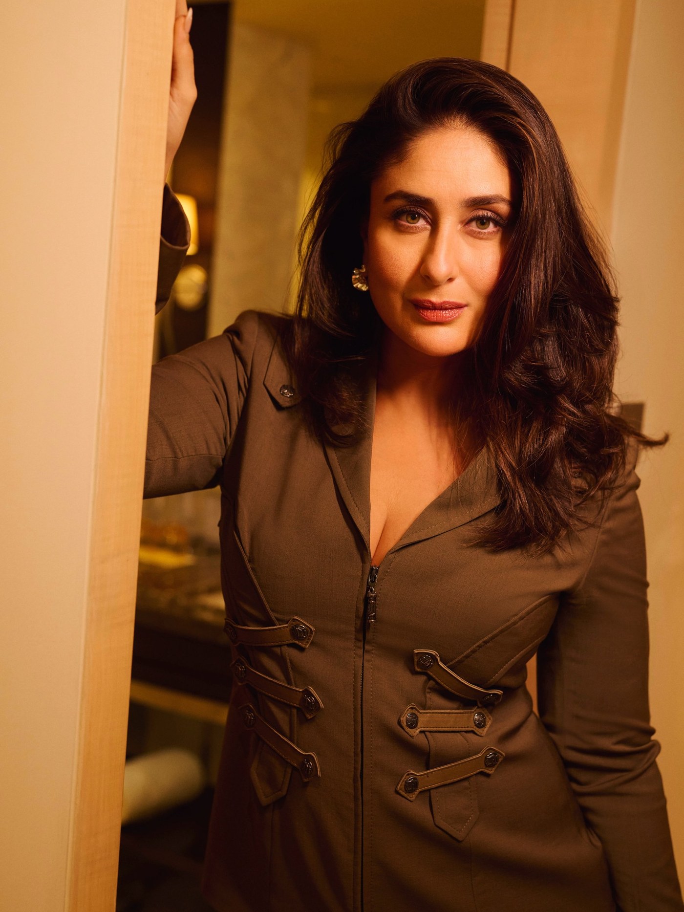 Kareena Kapoor captures a moment of sophisticated confidence in tailored olive and khaki tones.
