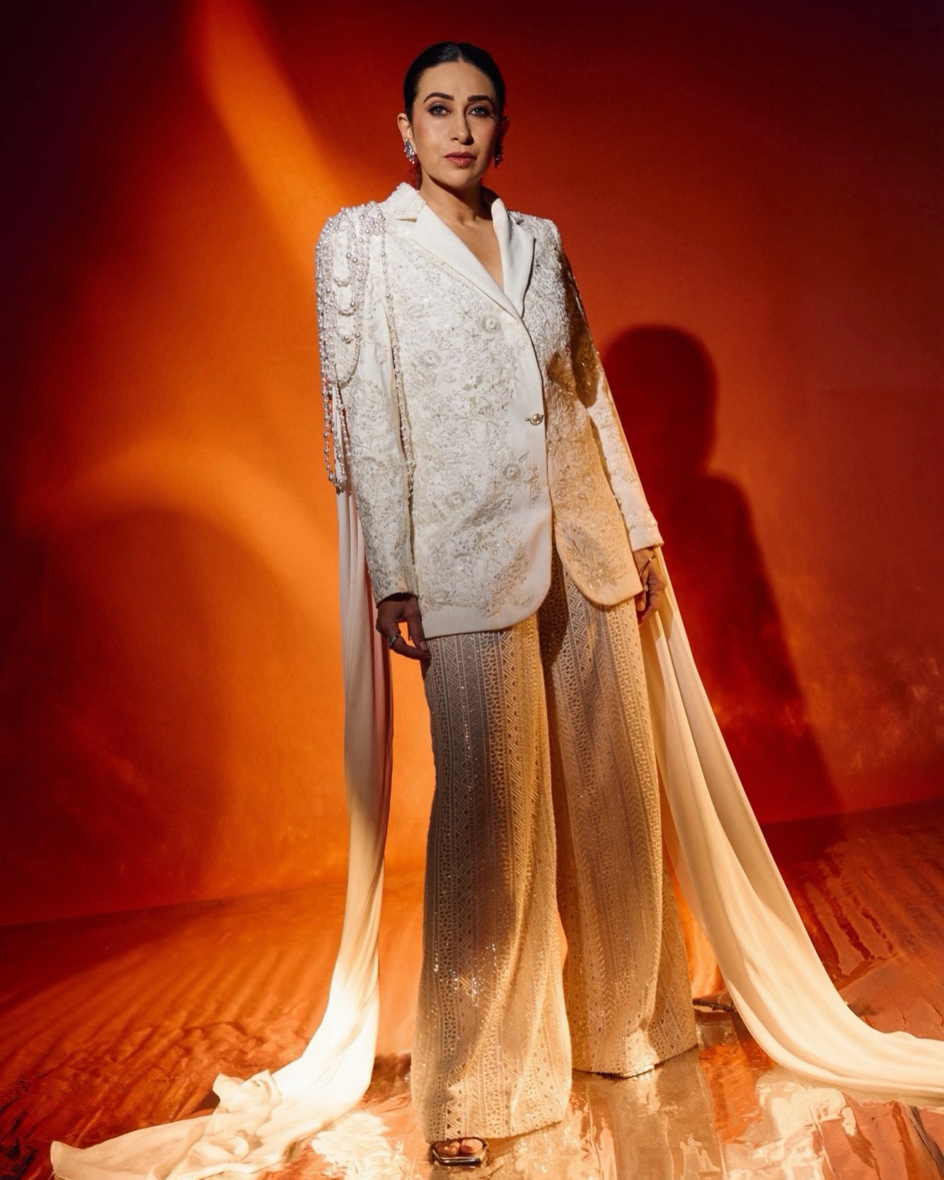 Karisma Kapoor radiates regal modernity in a structured, intricately embroidered white ensemble. - Photos & Updates