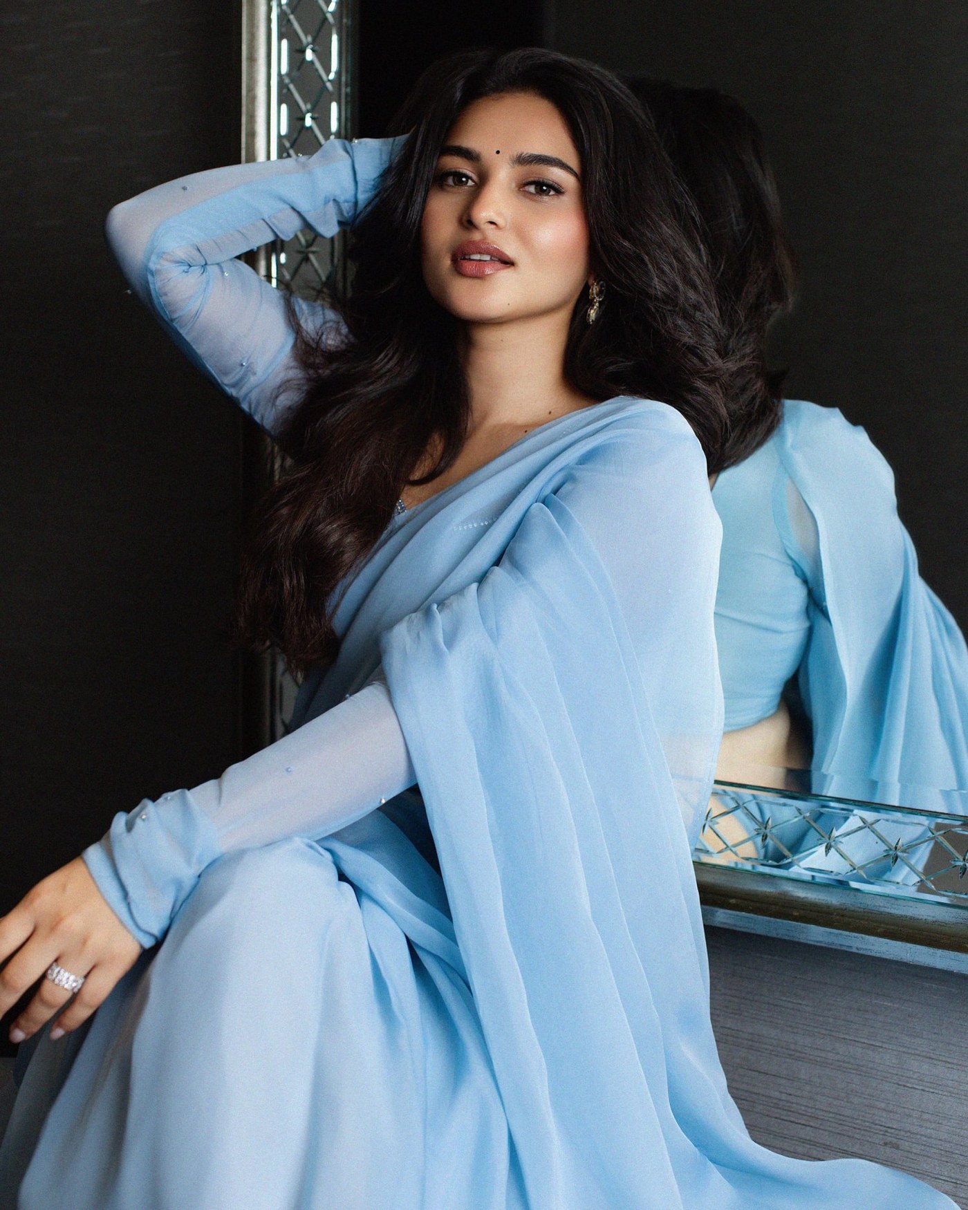 Kayadu Lohar poses elegantly in a stunning pastel blue saree, showcasing sophisticated ethnic style.