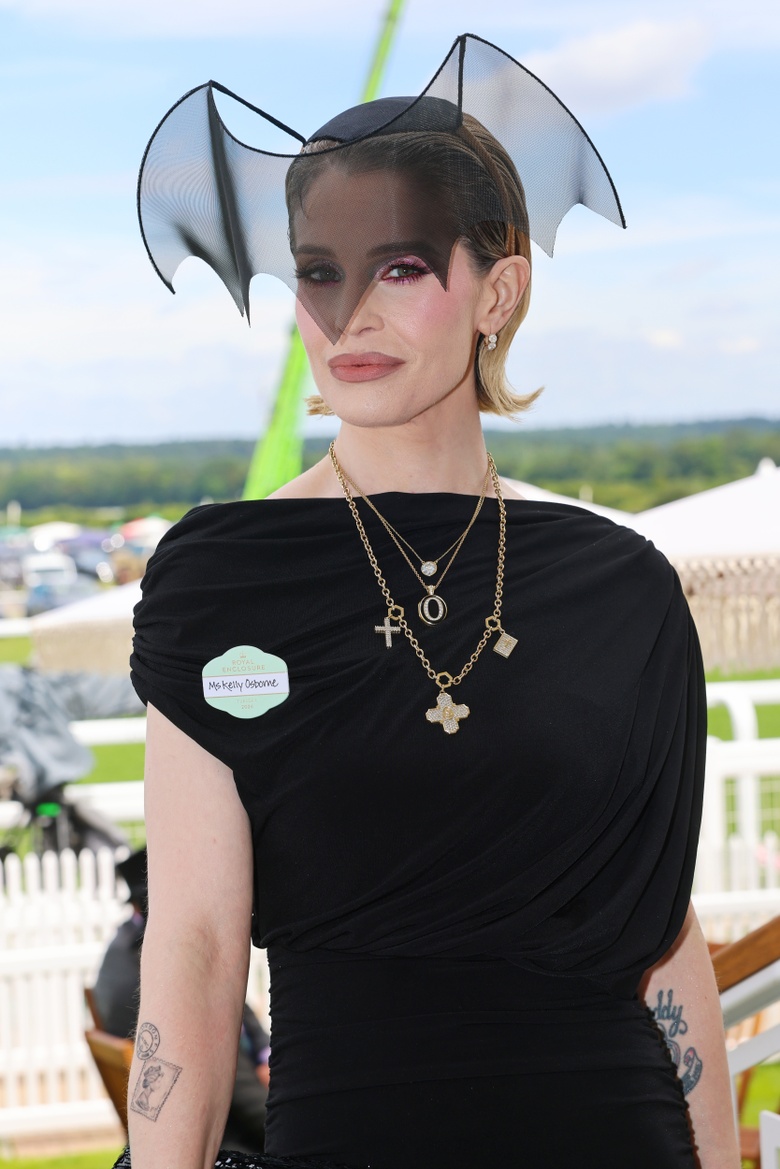 Kelly Osbourne posing in a striking outfit at an event.