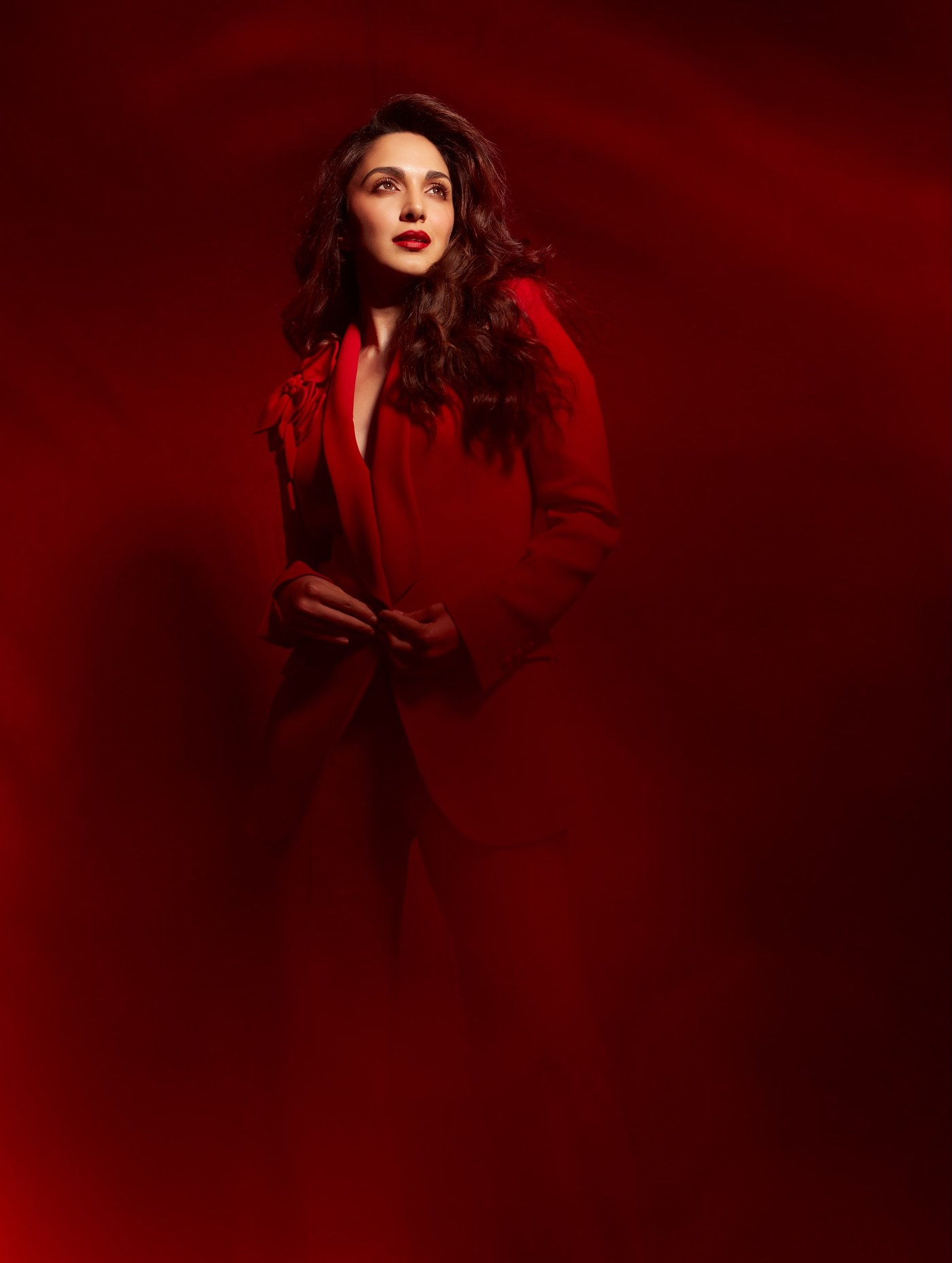 Kiara Advani is pictured showcasing her striking 'Peek A Boo' fashion moment in a bold, tailored red blazer ensemble.