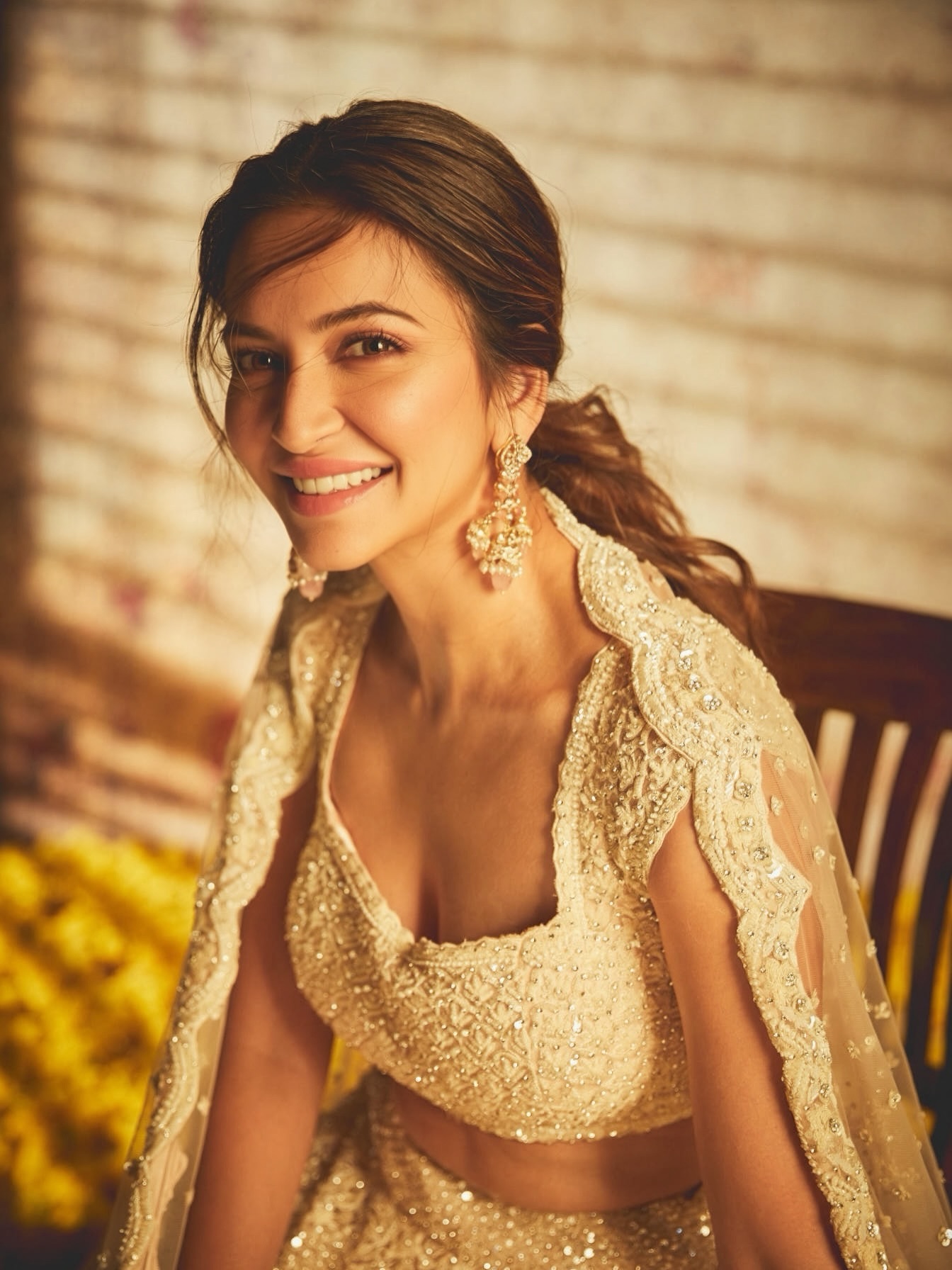 Kriti Kharbanda in an ivory and gold lehenga with warm lighting. - Photos & Updates