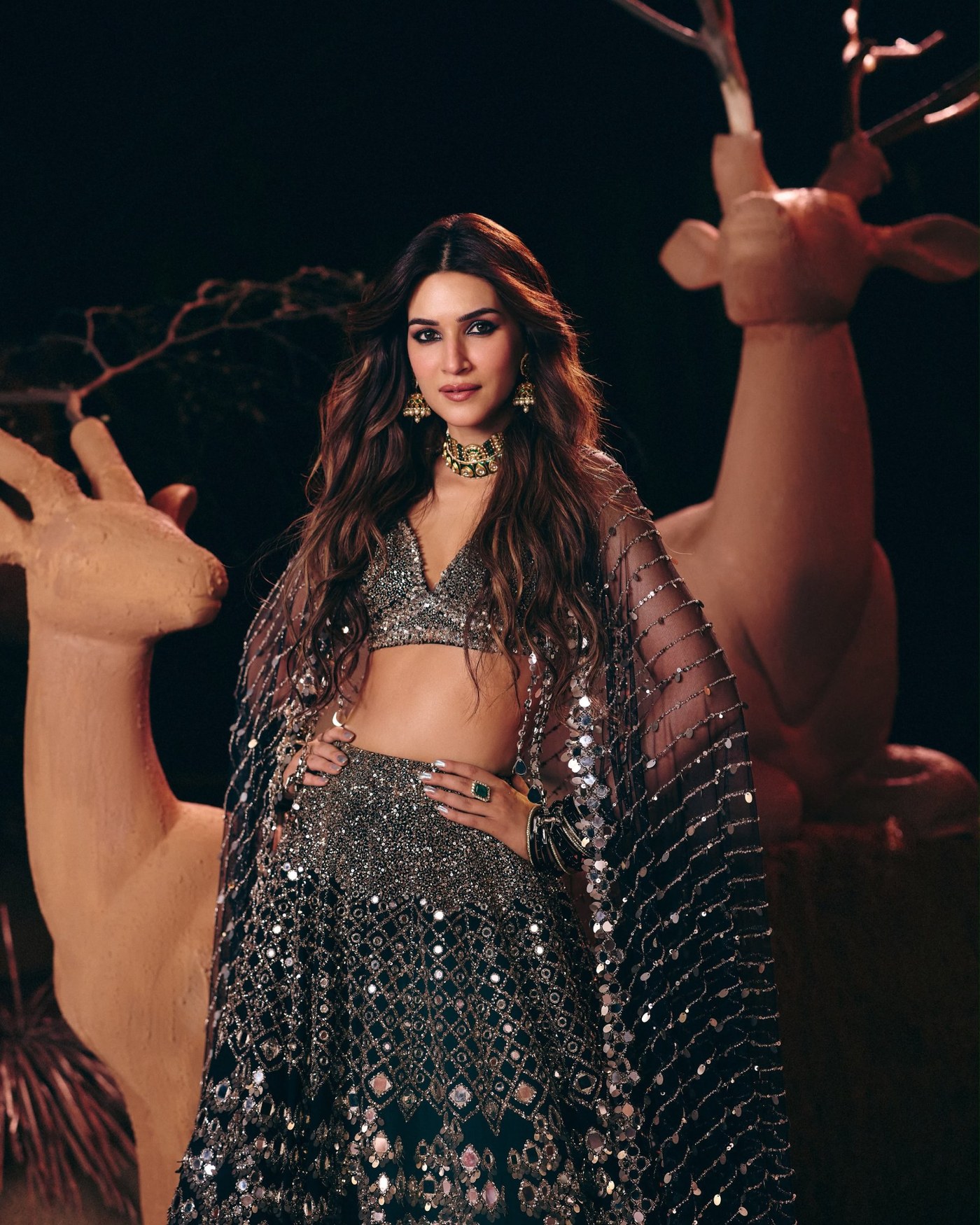 Kriti Sanon showcases silver mirror-work lehenga at Delhi couture event.
