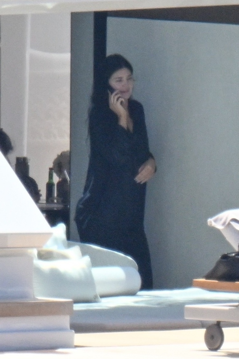 Kylie Jenner posing in a glamorous setting for a high-fashion photograph.