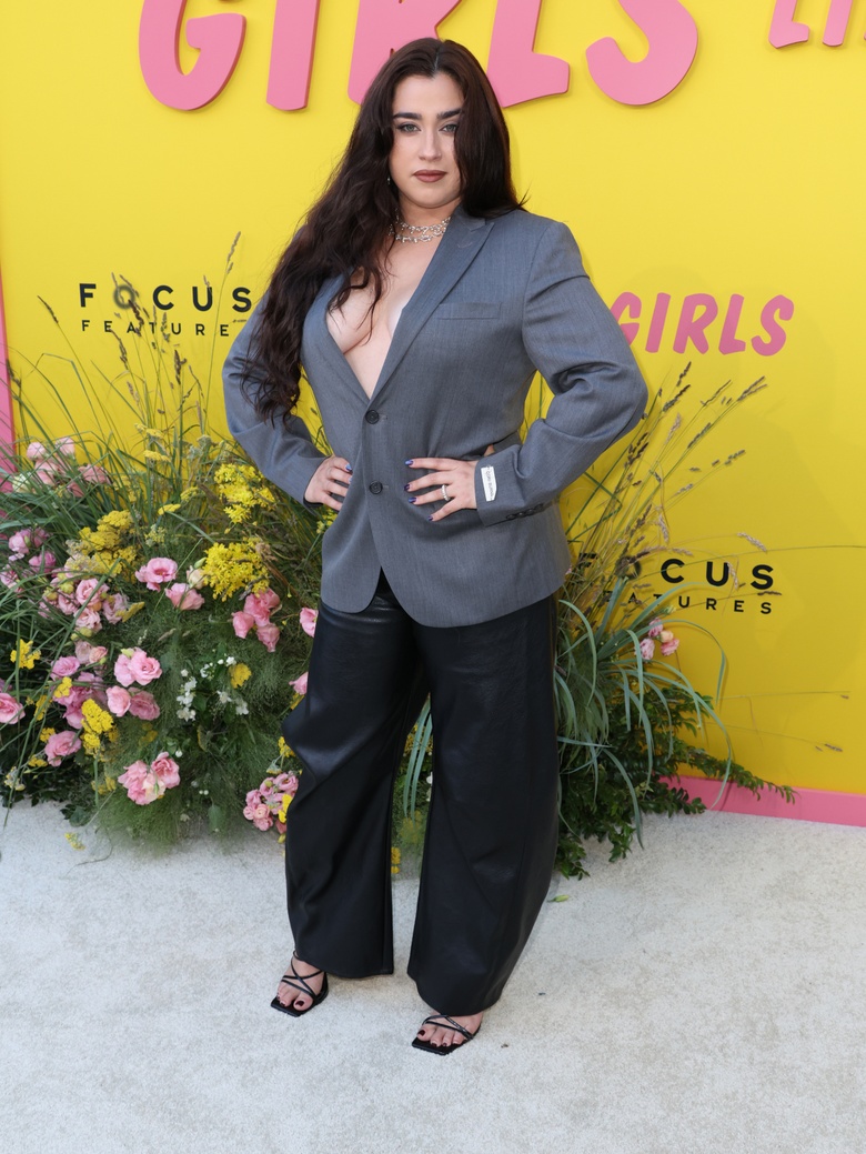 Lauren Jauregui posing in a vibrant, fashion-forward setting with striking styling.