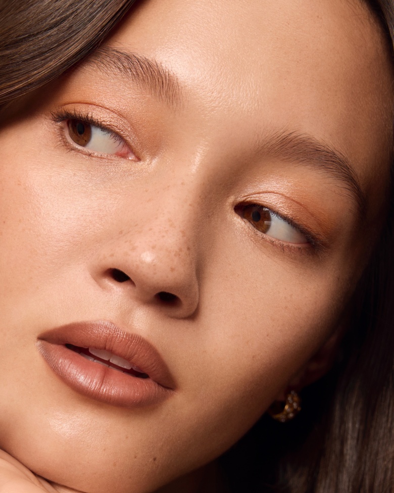 Lily Chee poses dramatically, showcasing high fashion elegance for a Louis Vuitton Beauty Campaign.