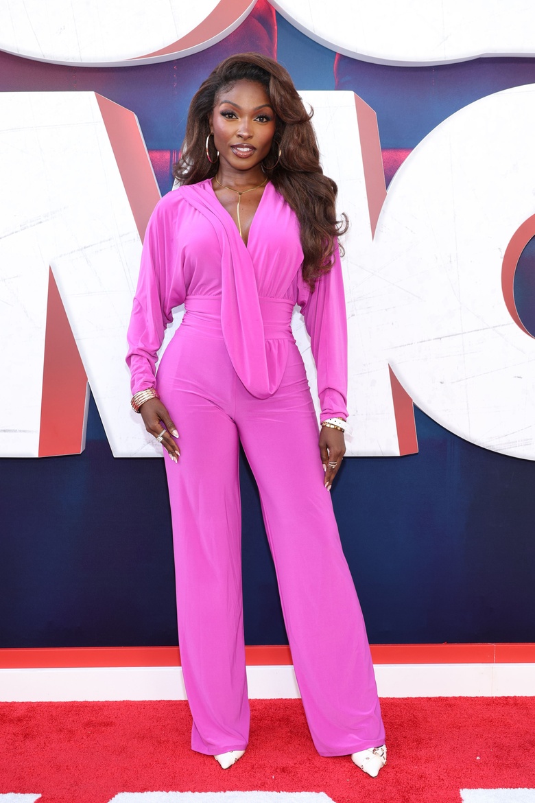 Loren Lott posing at an event, showcasing a vibrant outfit.