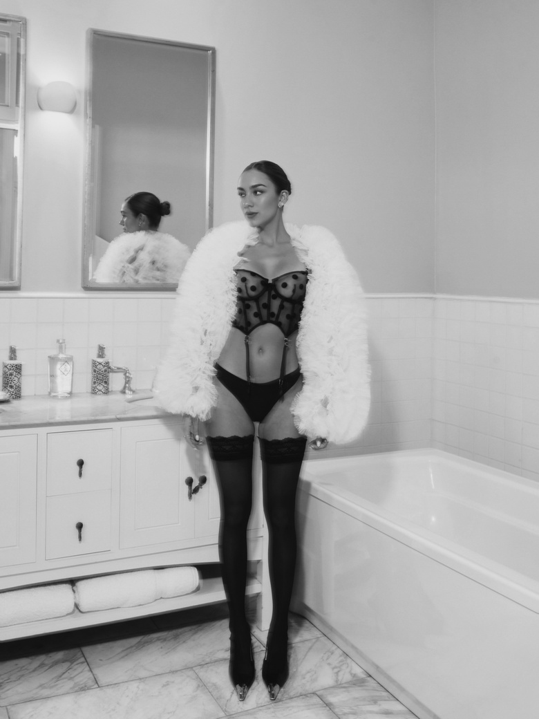 Luana Barron poses beautifully during an event showcasing sophisticated fashion choices.