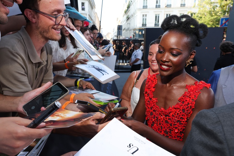 Lupita Nyongo Lights Up the Red Carpet in a Stunning Coral Lace Masterpiece