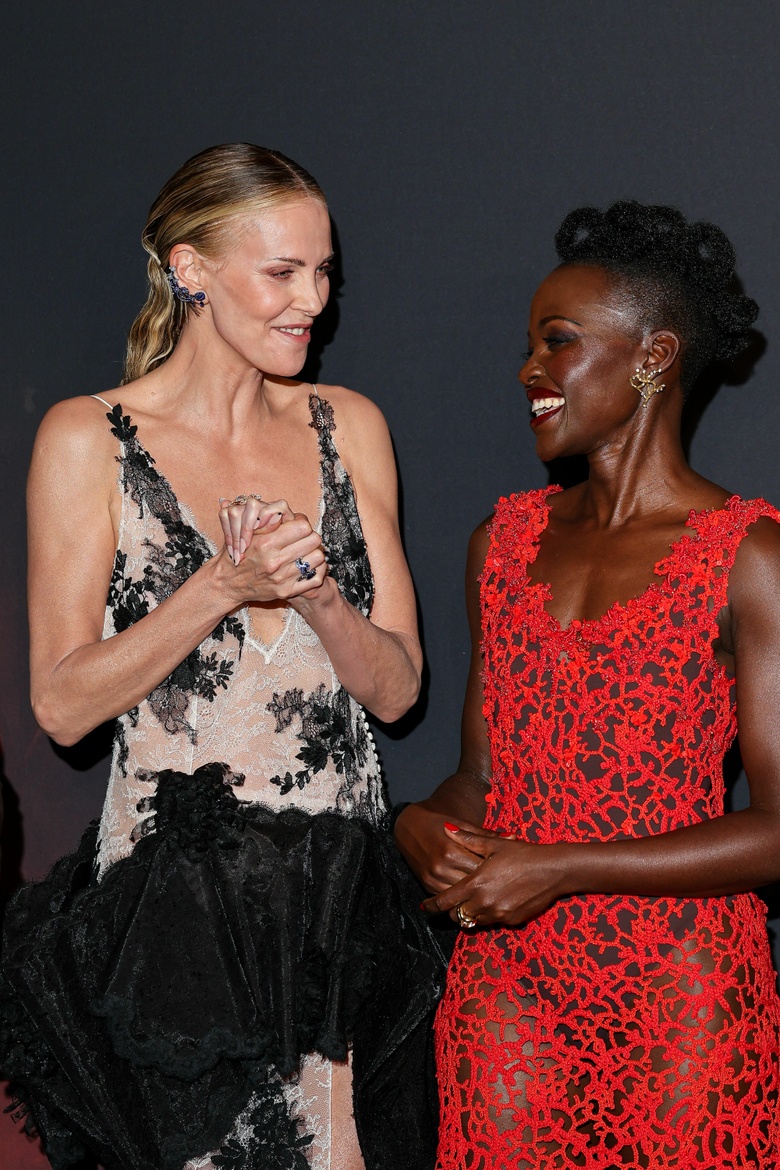Lupita Nyongo Lights Up the Red Carpet in a Stunning Coral Lace Masterpiece