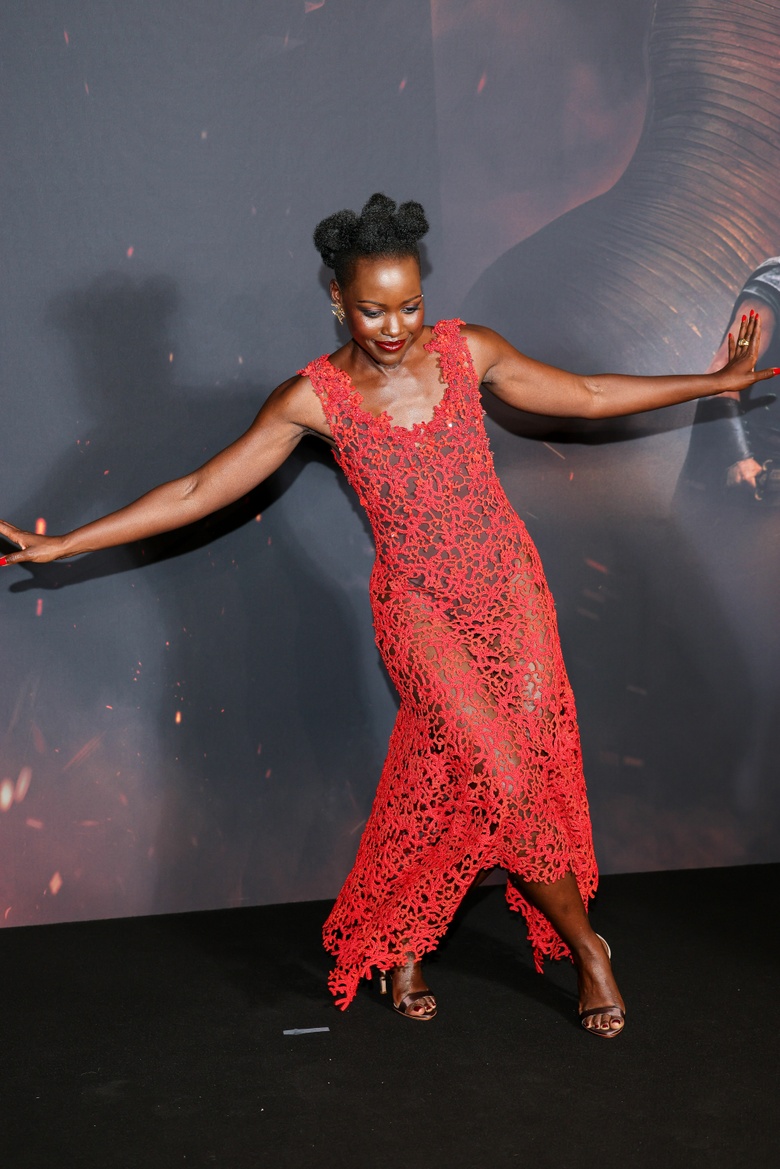 Lupita Nyongo Lights Up the Red Carpet in a Stunning Coral Lace Masterpiece