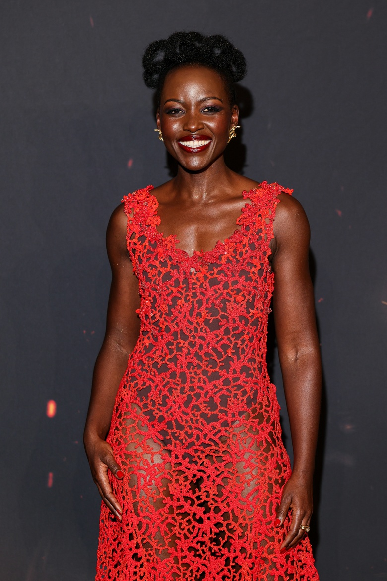 Lupita Nyongo Lights Up the Red Carpet in a Stunning Coral Lace Masterpiece