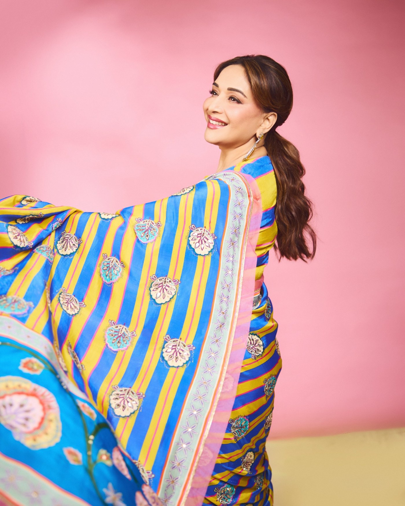Madhuri Dixit showcases a blue and yellow sari with pink and mint detailing. - Photos & Updates
