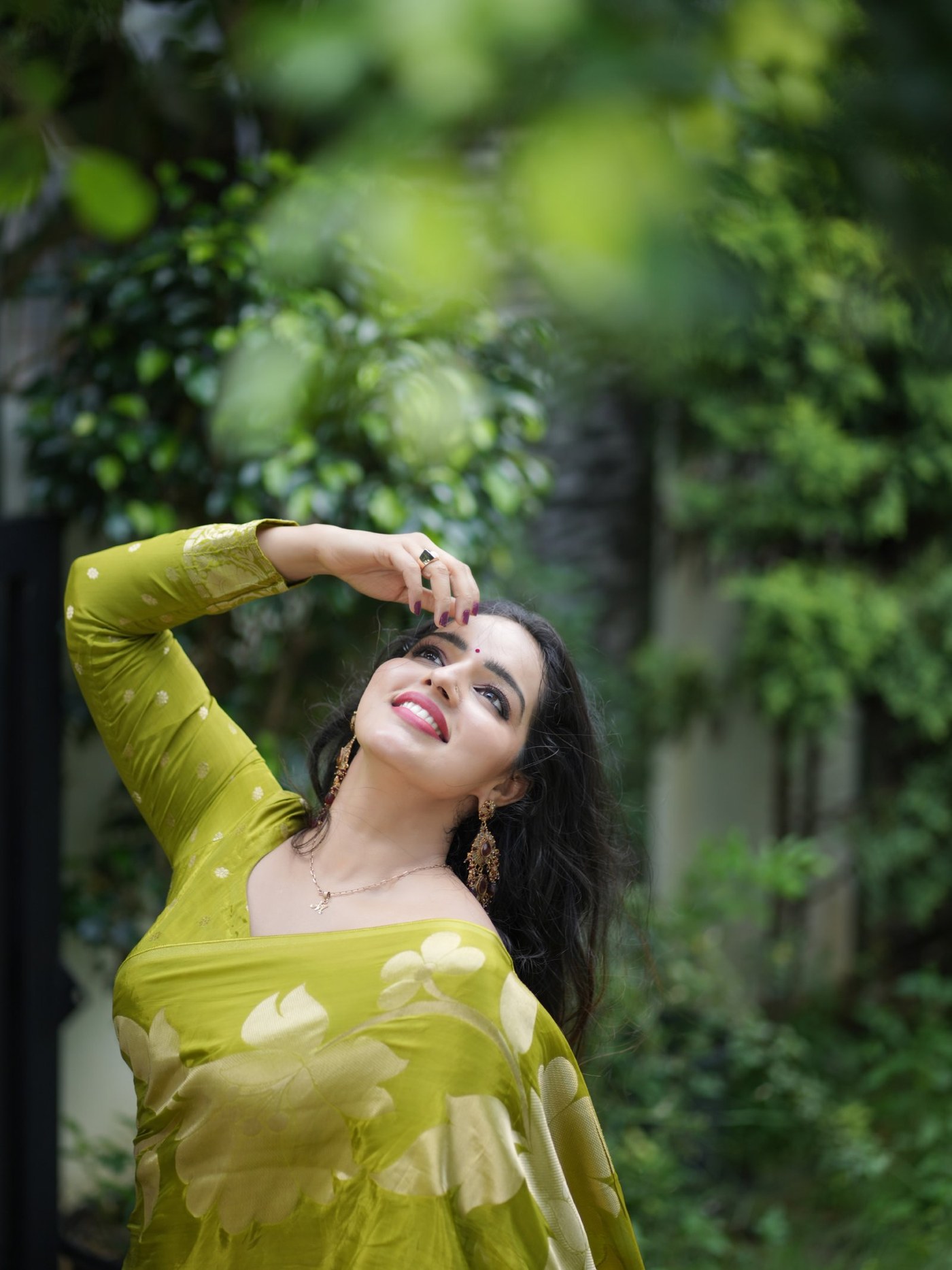Malavika Menon showcases her stunning traditional appearance in a bright lime-green silk saree.