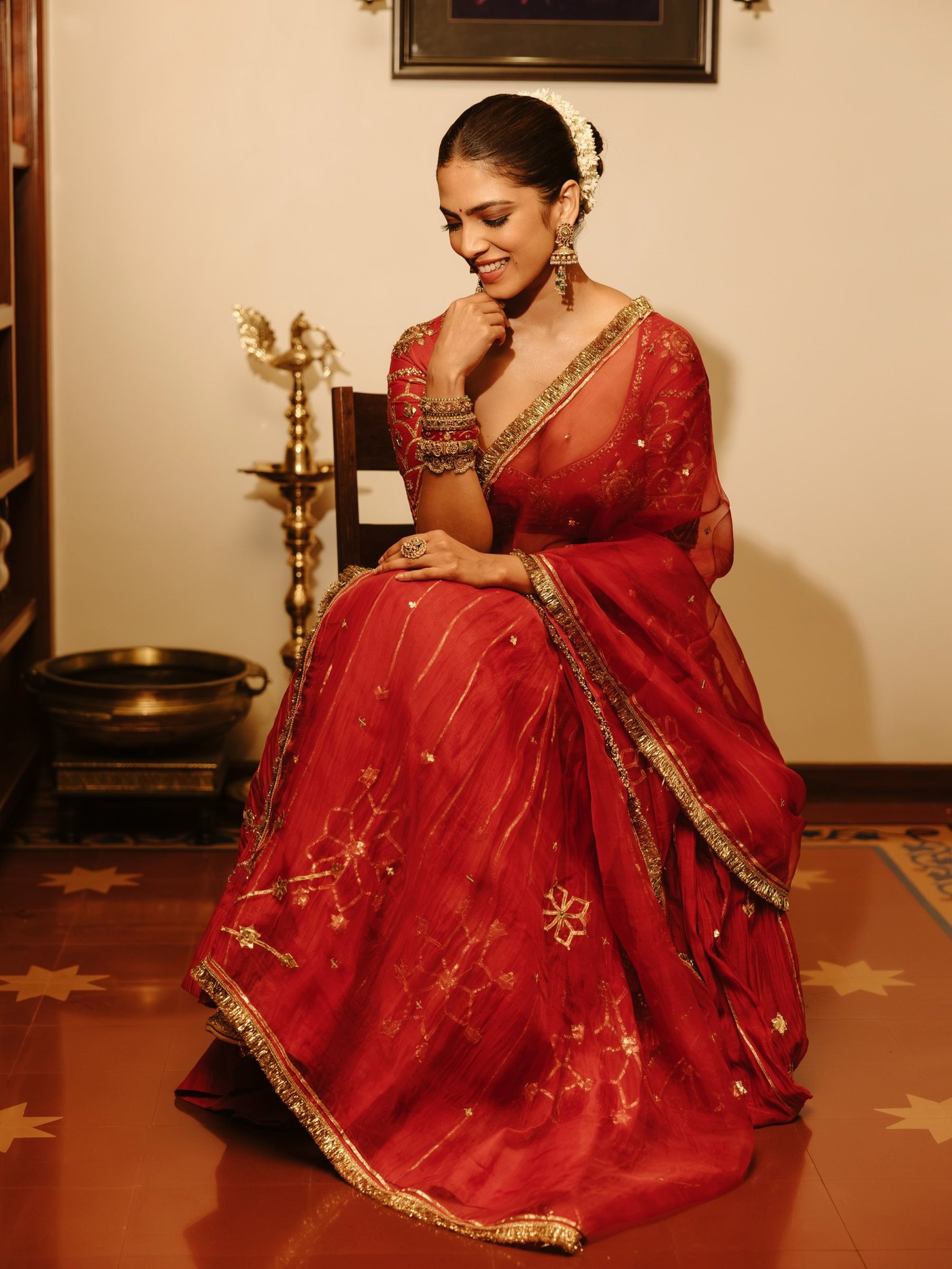 Malavika Mohanan in a richly detailed red lehenga ensemble. - Photos & Updates