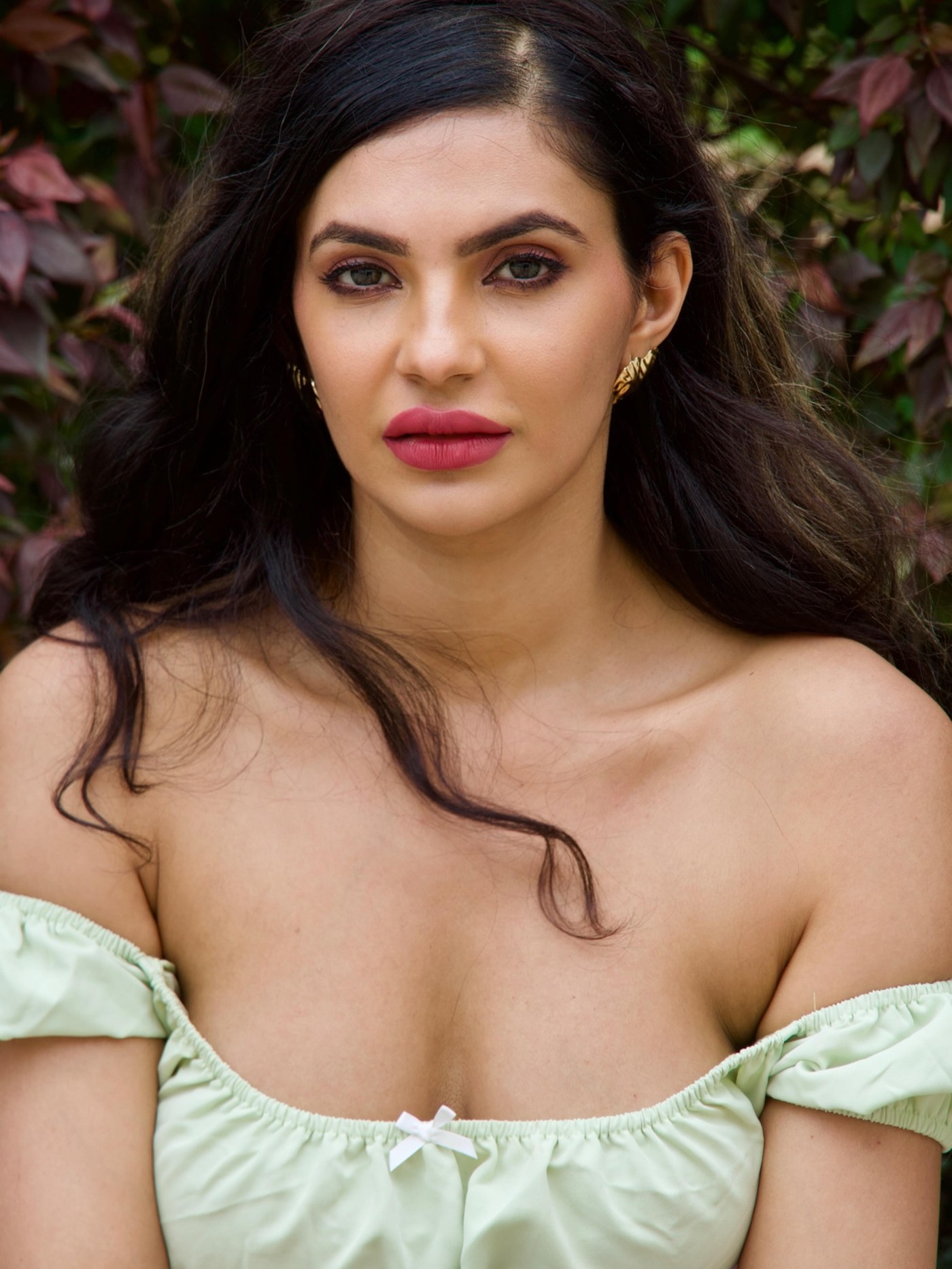 Manmeet Kaur Virk shines in a chic, light green off-shoulder crop top paired with distressed denim shorts.