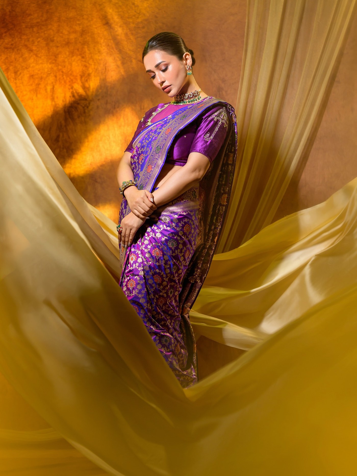 Mimi Chakraborty showcases a stunning regal purple saree paired with statement jewelry for a festive occasion. - Photos & Updates