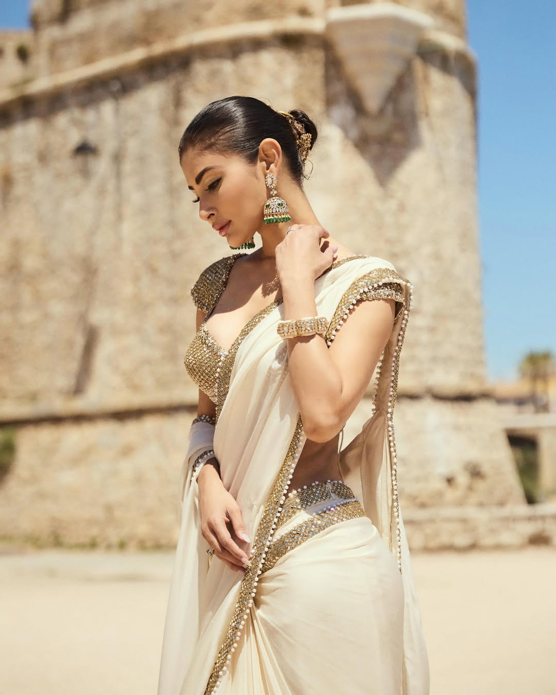 Mouni Roy Glows in Ivory Gold Saree: A Regal Beachside Dream
