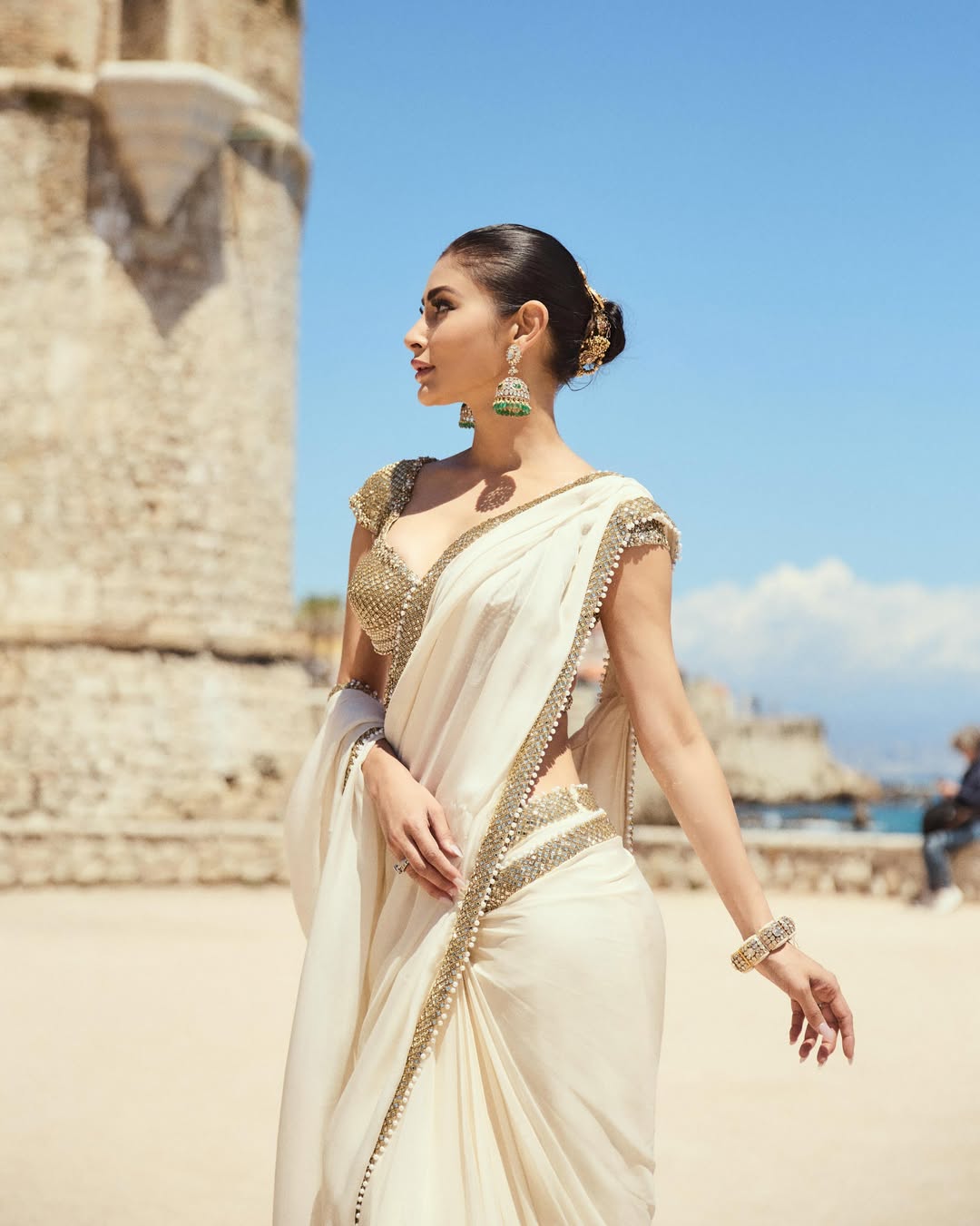 Mouni Roy Glows in Ivory Gold Saree: A Regal Beachside Dream
