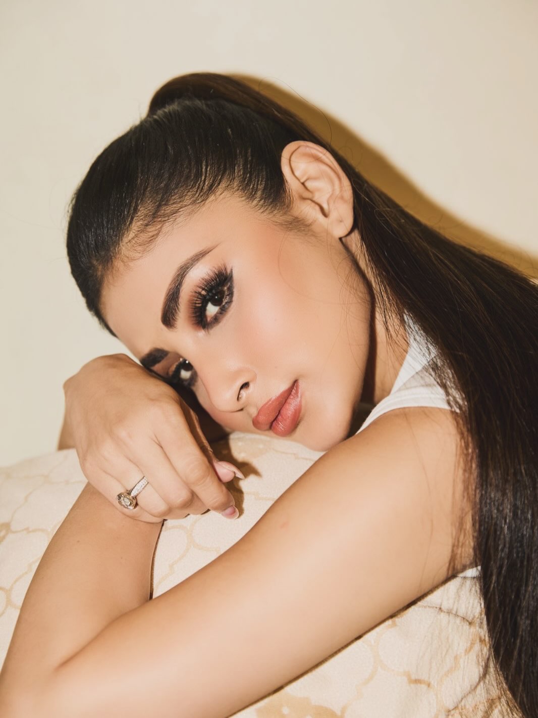 Mouni Roy models a fitted white sleeveless top with high-waisted jeans. - Photos & Updates