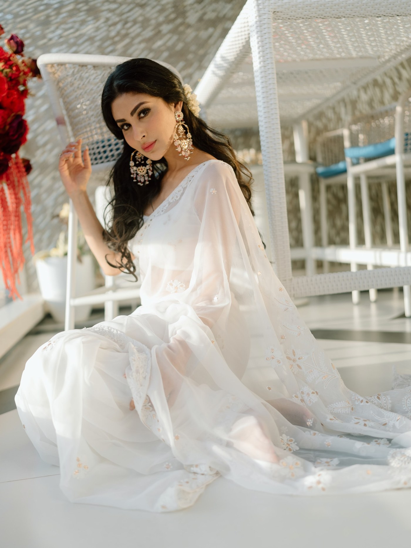 Mouni Roy is captured in a traditional drape, featuring soft, neutral tones and delicate embroidery detail.