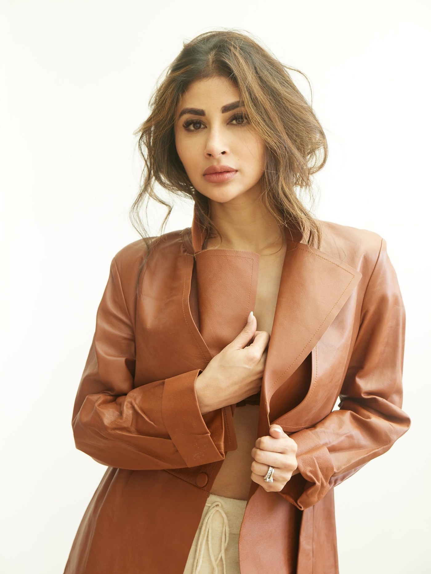 Mouni Roy showcases a bold, minimalist look in a studio setting.