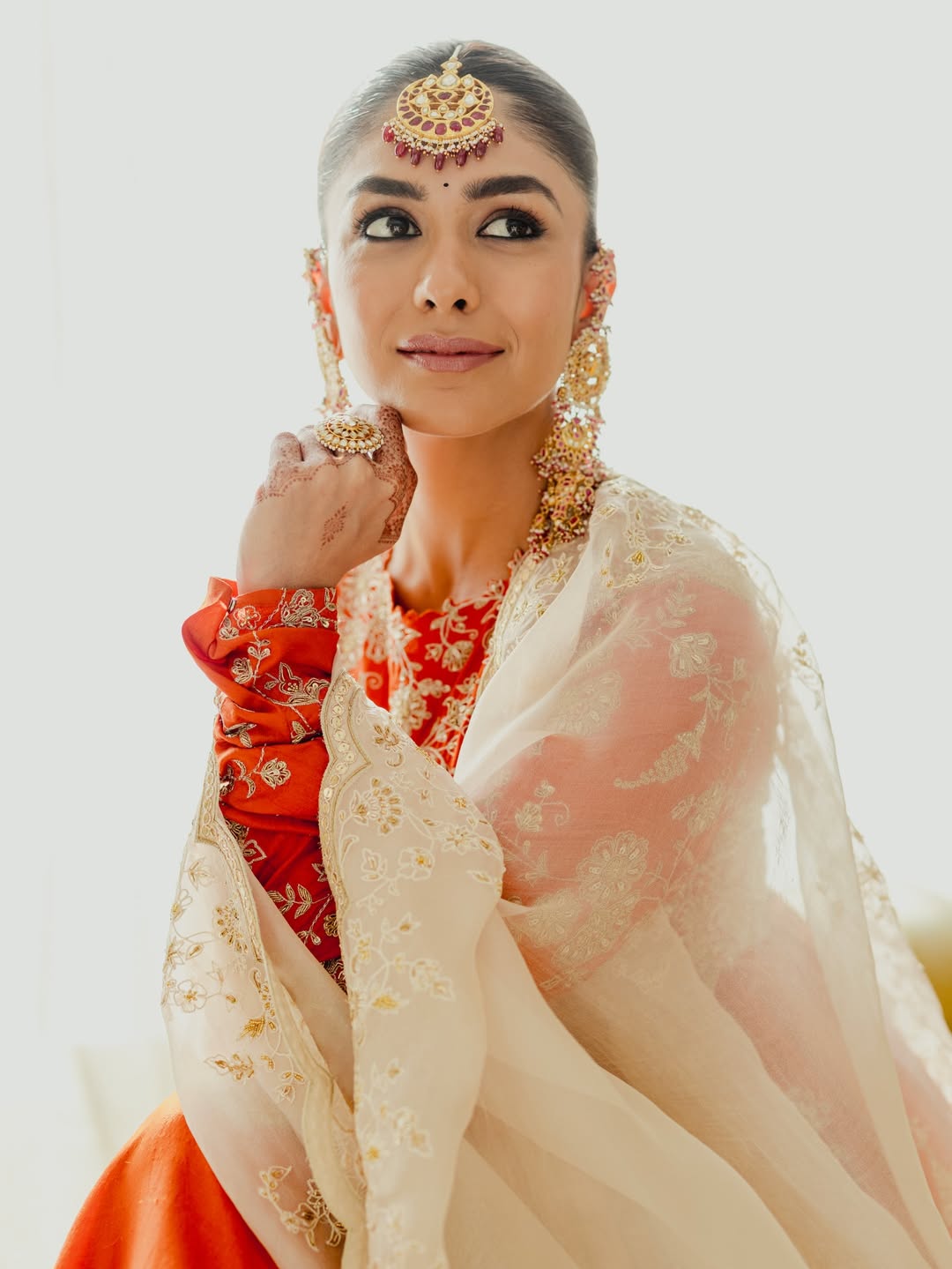 Mrunal Thakur's Regal Glow: Gold and Vermilion Splendor